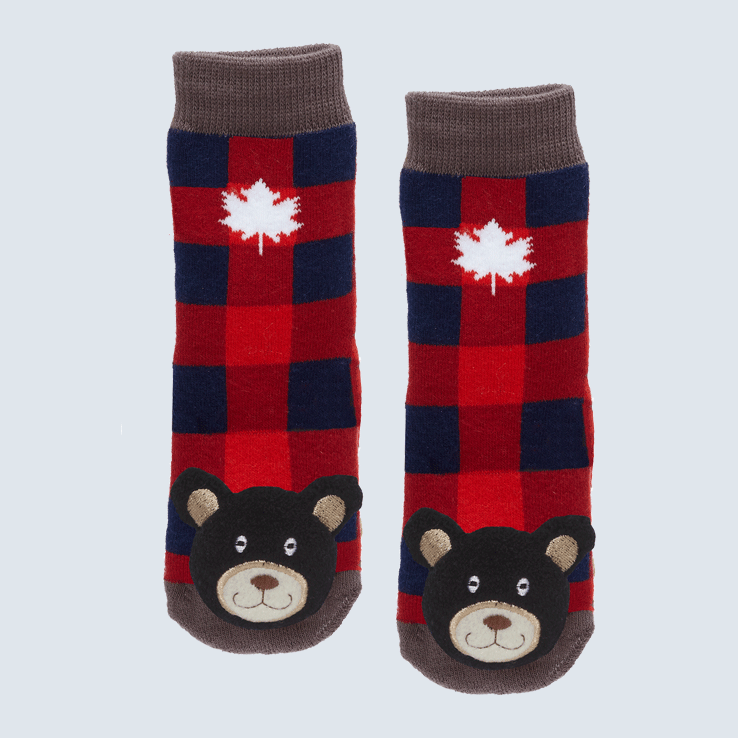 Two plaid socks against a white background. The socks feature a white maple leaf and a cute plush bear charm on the toe.
