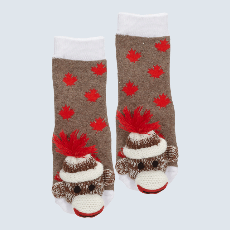 Two socks against a white background. The socks are made of a brown sock monkey fabric with red maple leaf motifs. Each socks has a monkey charm on the toe.