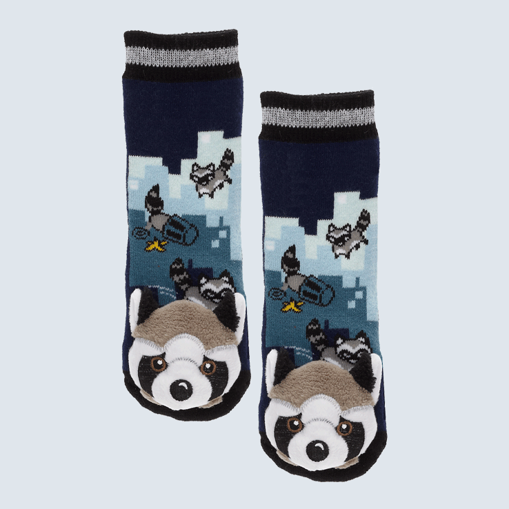 Two dark blue socks against a white background. The socks feature a raccoon and trash can motif and a cute plush raccoon charm on each toe.