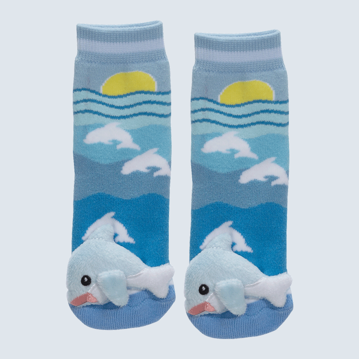 Two blue socks against a white background. The socks feature a sun and sea motif with a a plush dolphin on each toe.