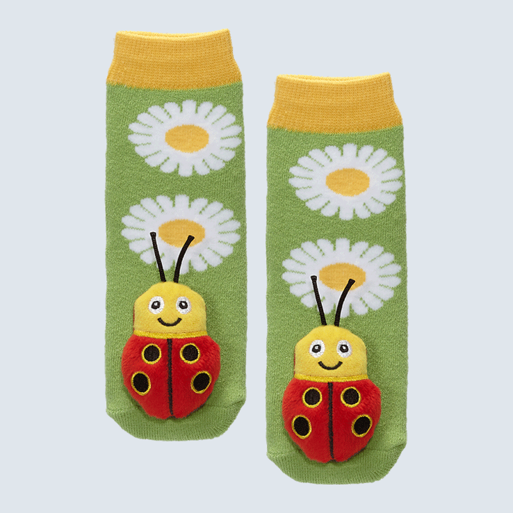 Two socks against a white background. The socks feature two daisies and a cute plush lady bug charm on each toe.
