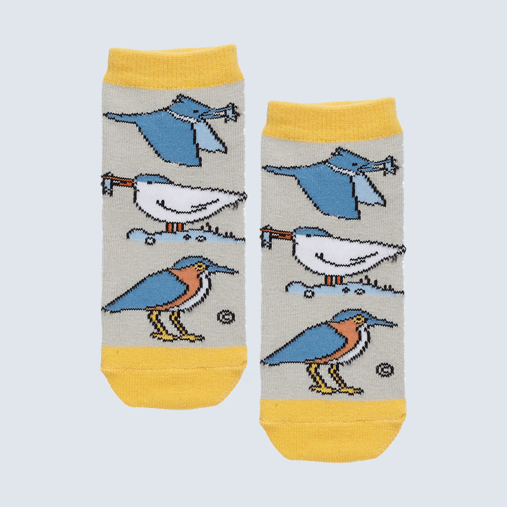 Two small socks against a white backdrop. The socks feature a gray and yellow and a motif with four sea birds.
