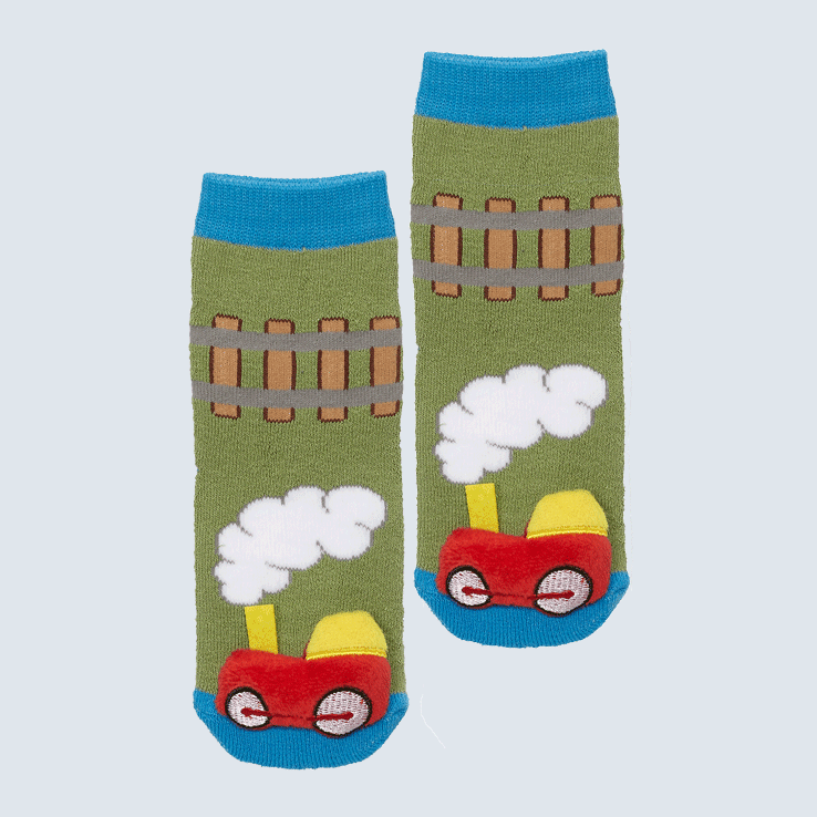Two socks against a white background. The socks feature a train track pattern and a cute plush train charm on the toe.